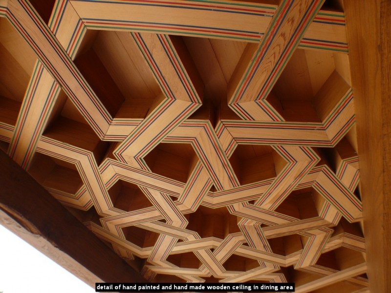 detail of hand painted and hand made wooden ceiling in dining area