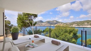 A magnificent villa standing on the rocks directly overlooking the sea in a breathtaking natural setting.